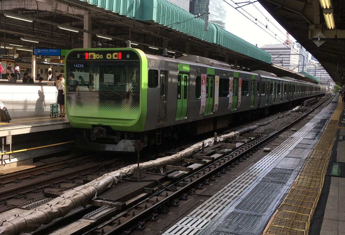 山手線の電車であるE235系を駅のホームから撮影した写真です。E235系が斜め左に向いています。